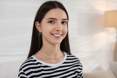 Photo of Portrait of smiling teenage girl at home