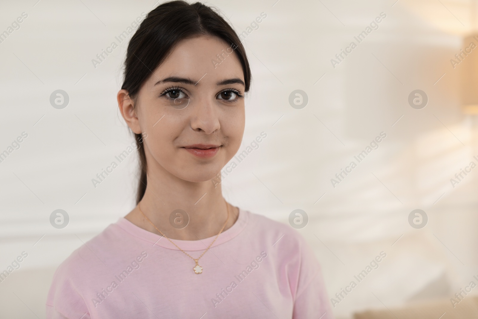 Photo of Portrait of beautiful teenage girl at home. Space for text