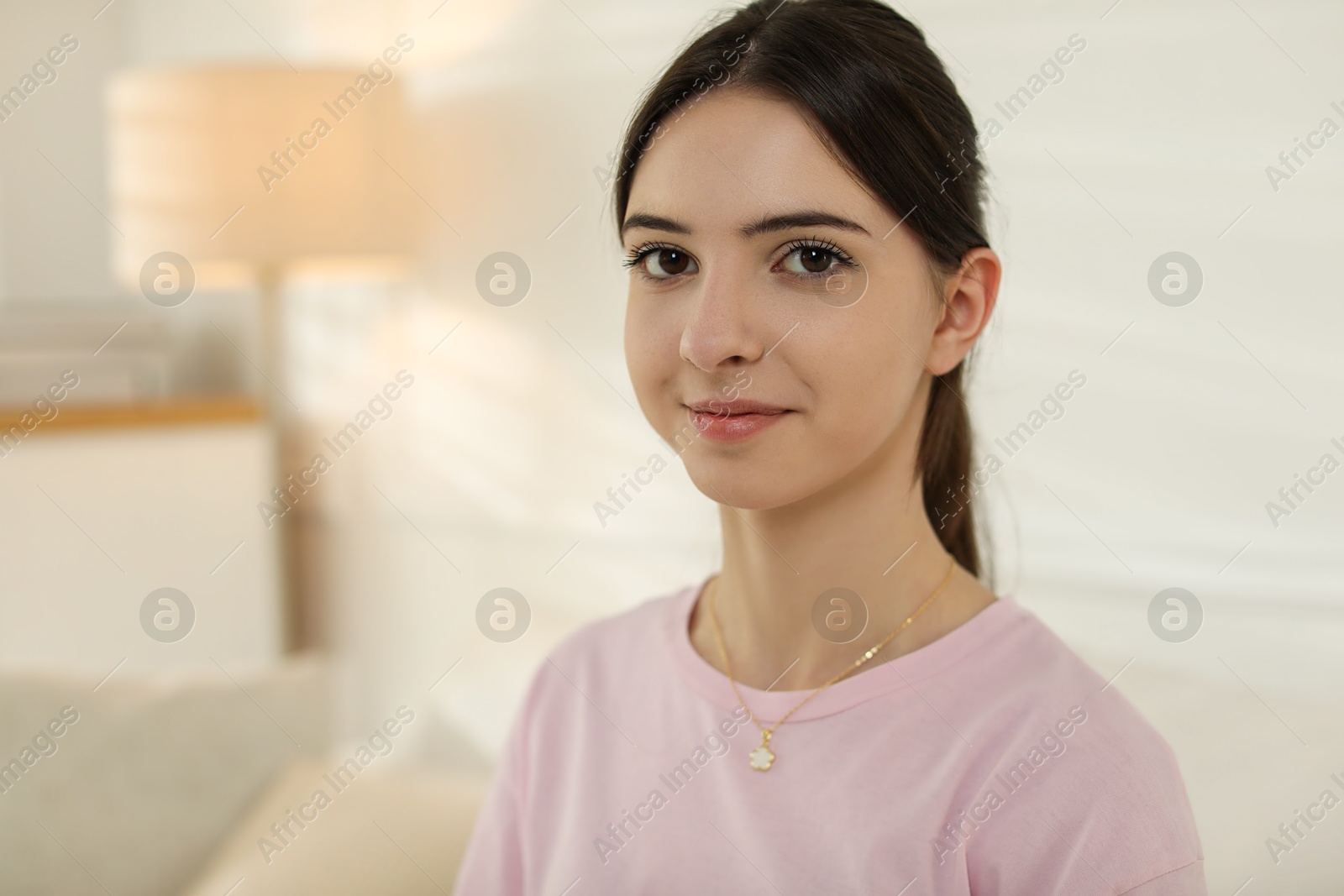 Photo of Portrait of beautiful teenage girl at home. Space for text