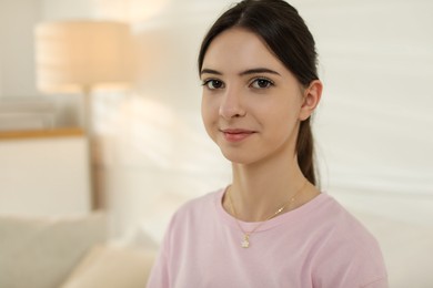 Photo of Portrait of beautiful teenage girl at home. Space for text