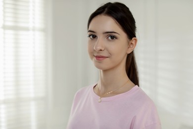 Photo of Portrait of beautiful teenage girl at home. Space for text