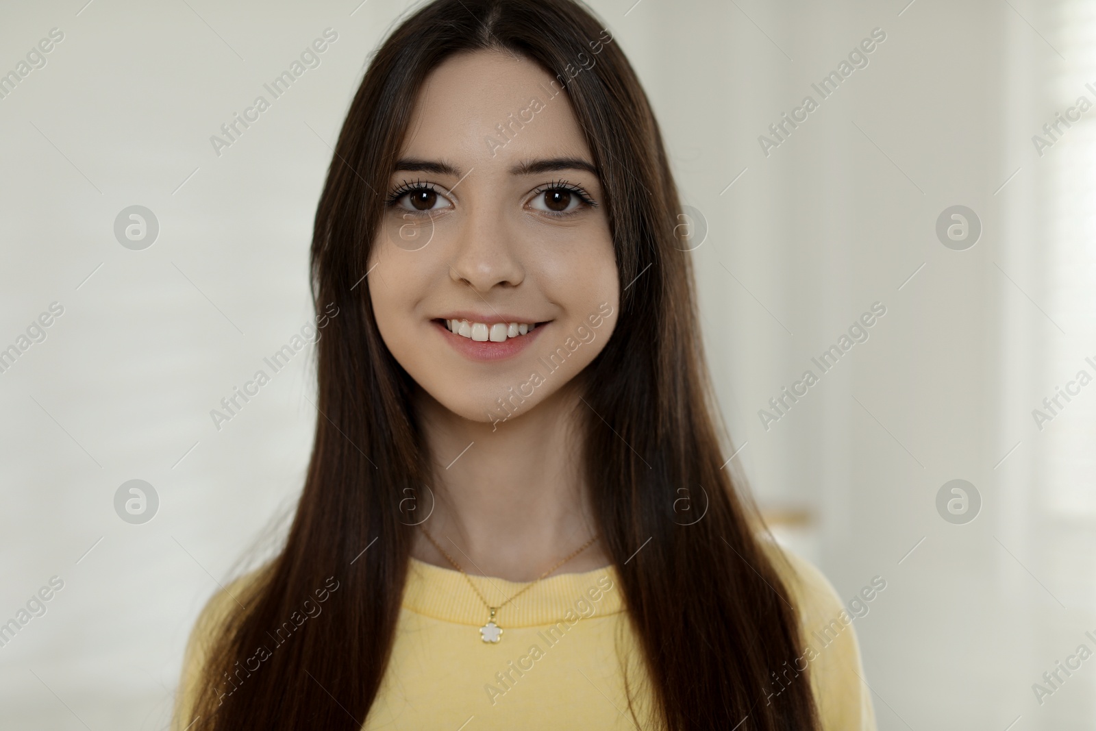 Photo of Portrait of happy teenage girl at home