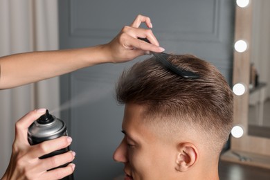 Photo of Hair cutting. Professional hairdresser working with client in barbershop, closeup