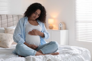 Photo of Portrait of beautiful pregnant woman on bed at home