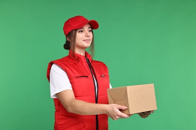 Photo of Girl in uniform with parcel on green background. Work for teenagers