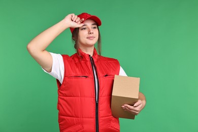 Photo of Girl in uniform with parcel on green background. Work for teenagers