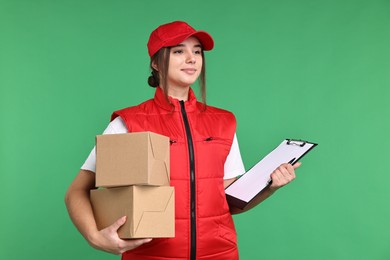 Photo of Girl in uniform with parcels and clipboard on green background. Work for teenagers