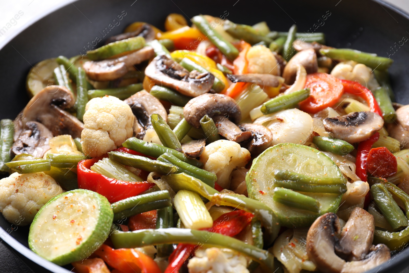 Photo of Different vegetables and mushrooms in frying pan, closeup