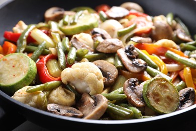 Photo of Different vegetables and mushrooms in frying pan, closeup