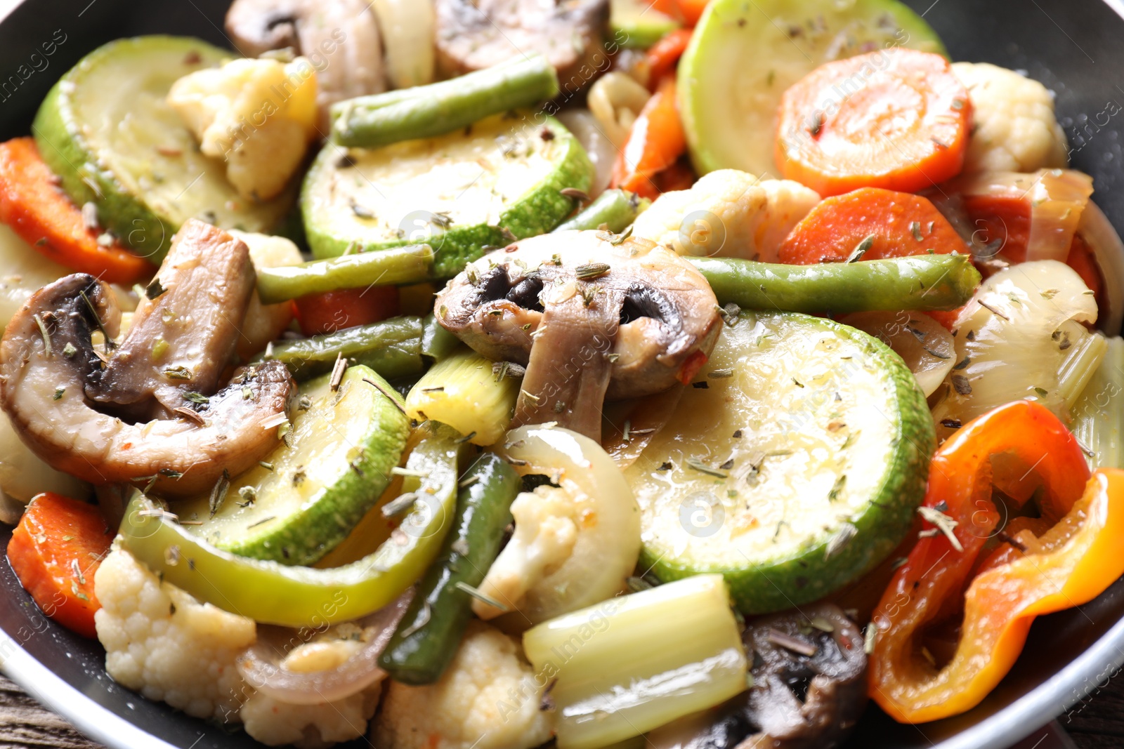 Photo of Different vegetables and mushrooms in frying pan, closeup