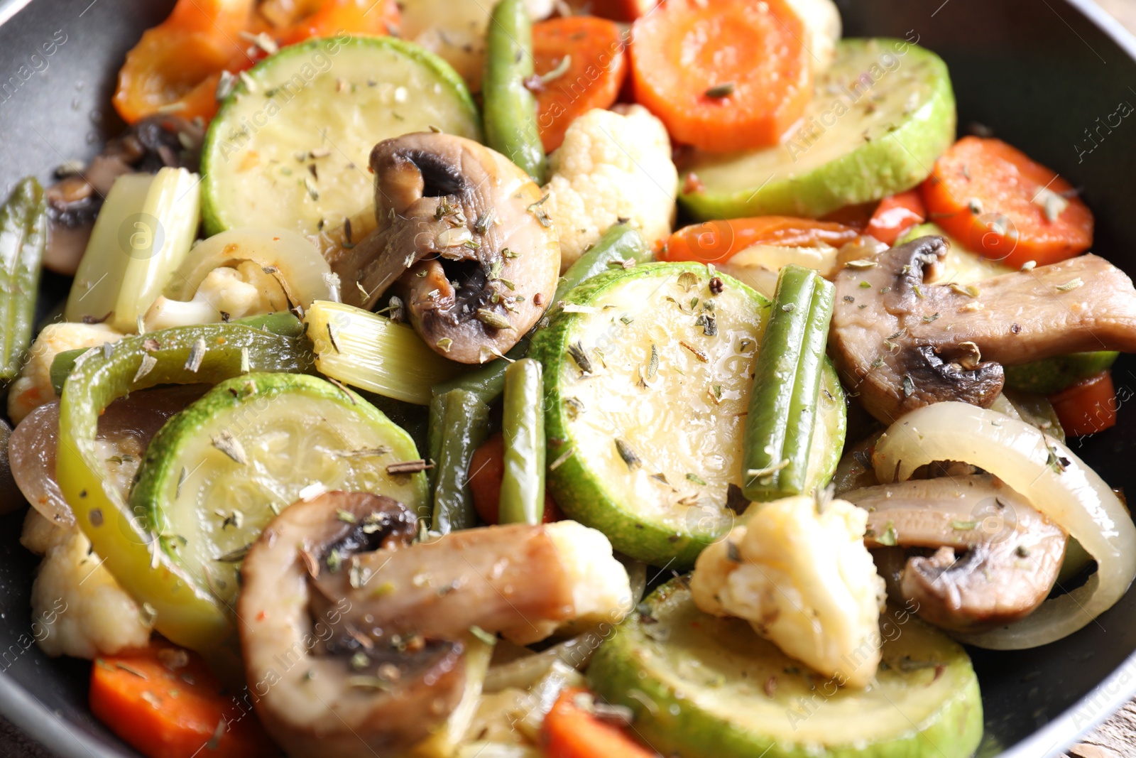 Photo of Different vegetables and mushrooms in frying pan, closeup