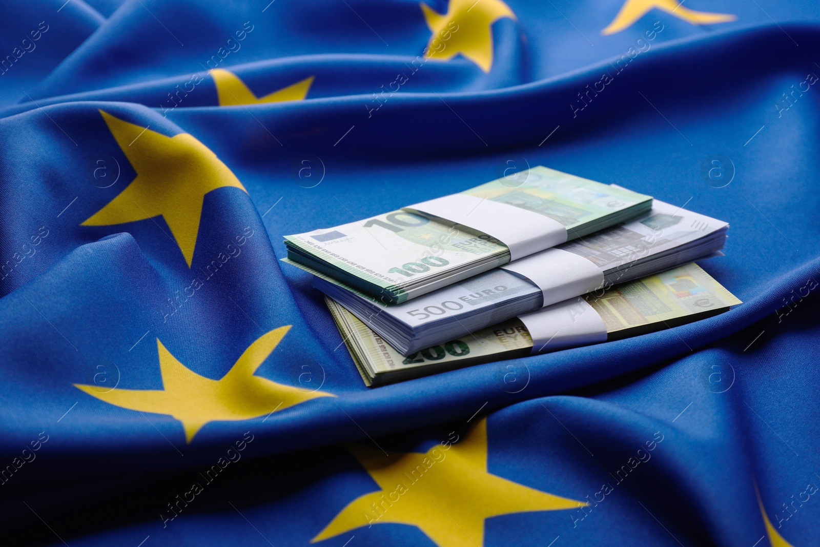 Photo of Bundles of euro banknotes on European Union flag