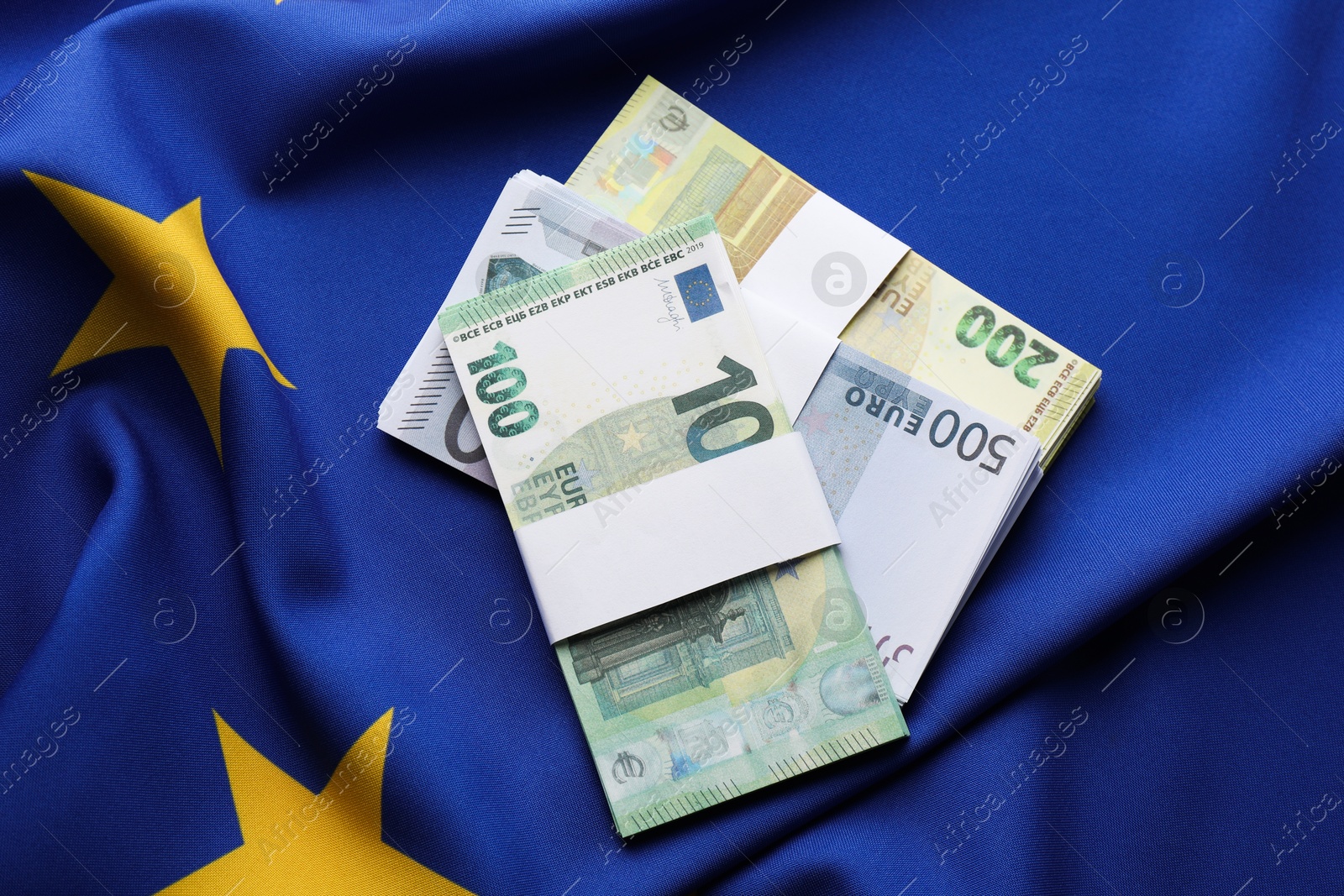 Photo of Euro banknotes on European Union flag, top view