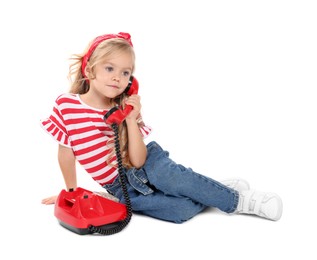 Photo of Cute little girl with telephone on white background