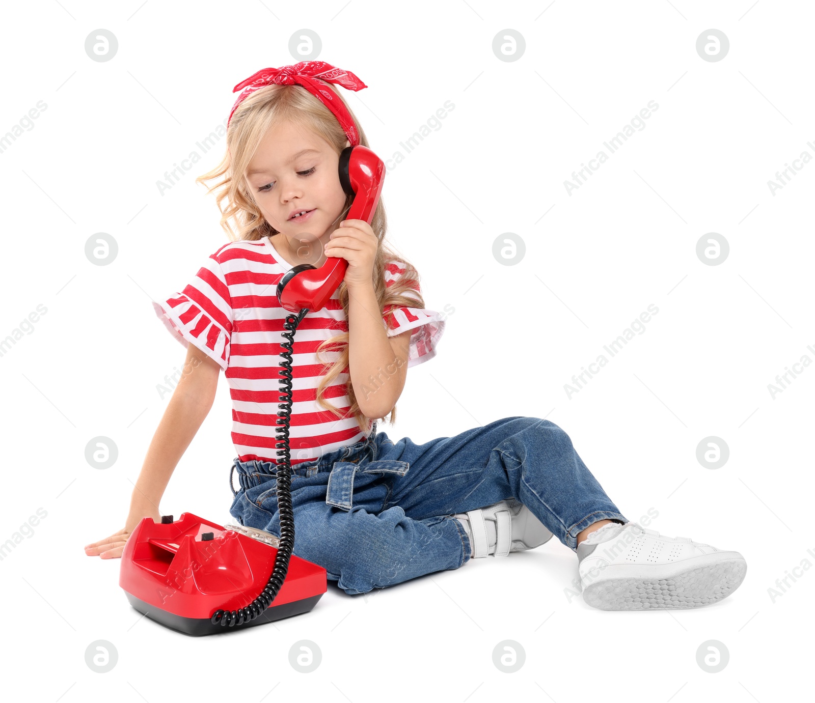 Photo of Cute little girl with telephone on white background