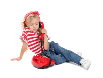 Photo of Cute little girl with telephone on white background