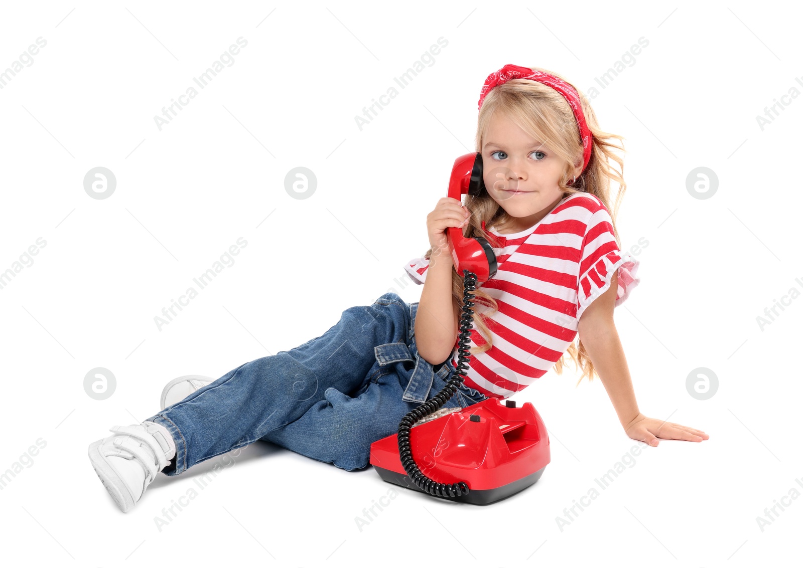 Photo of Cute little girl with telephone on white background