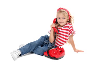 Cute little girl with telephone on white background