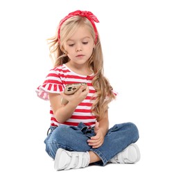 Photo of Cute little girl with smartphone on white background