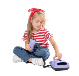 Cute little girl with telephone on white background