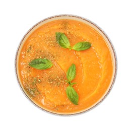 Photo of Delicious sweet potato soup with basil in bowl isolated on white, top view