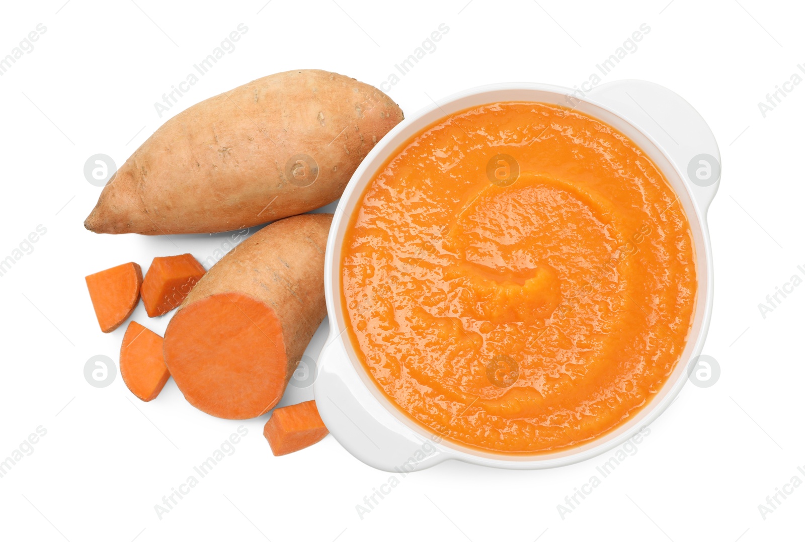 Photo of Delicious sweet potato soup and fresh vegetables isolated on white, top view