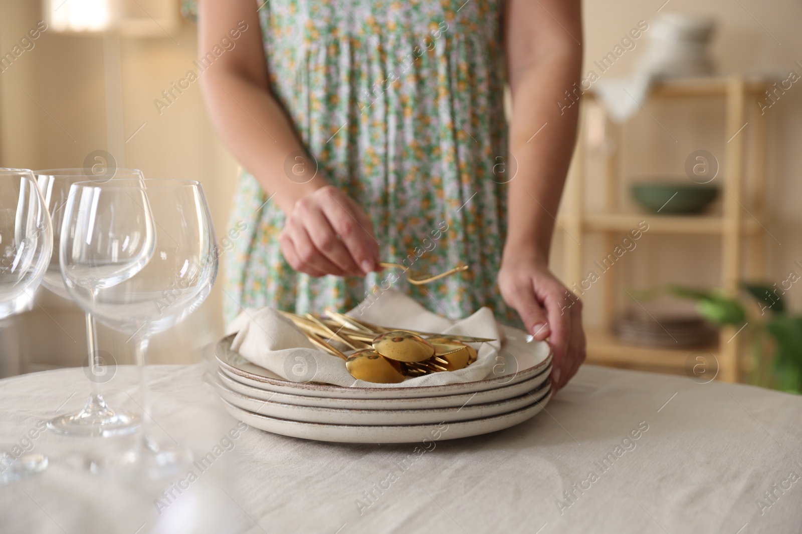 Photo of Woman setting table for dinner at home, closeup