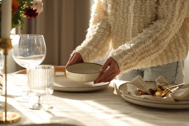 Photo of Woman setting table for dinner at home, closeup