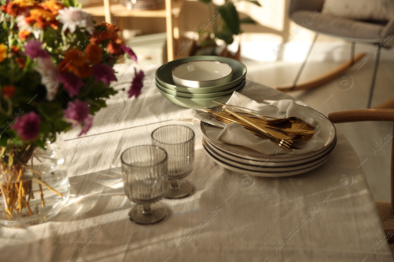 Photo of Stylish table setting with dishware, glasses and beautiful flowers indoors