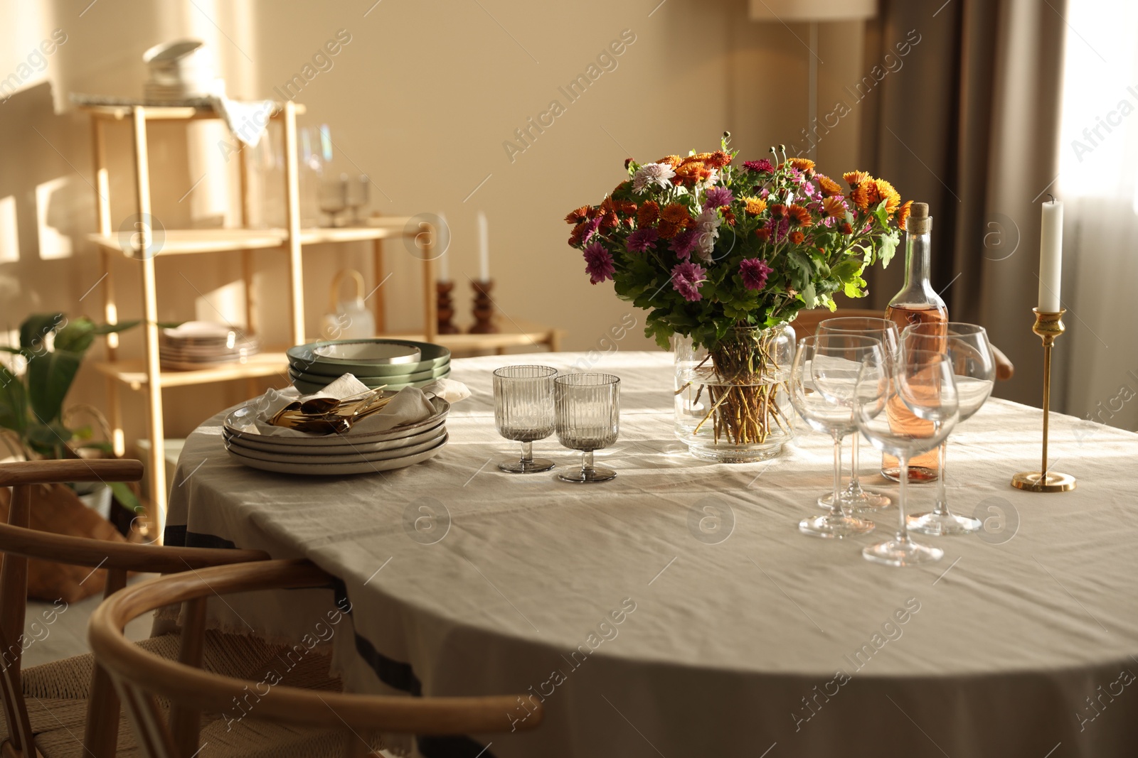 Photo of Stylish table setting with dishware, glasses and beautiful flowers indoors