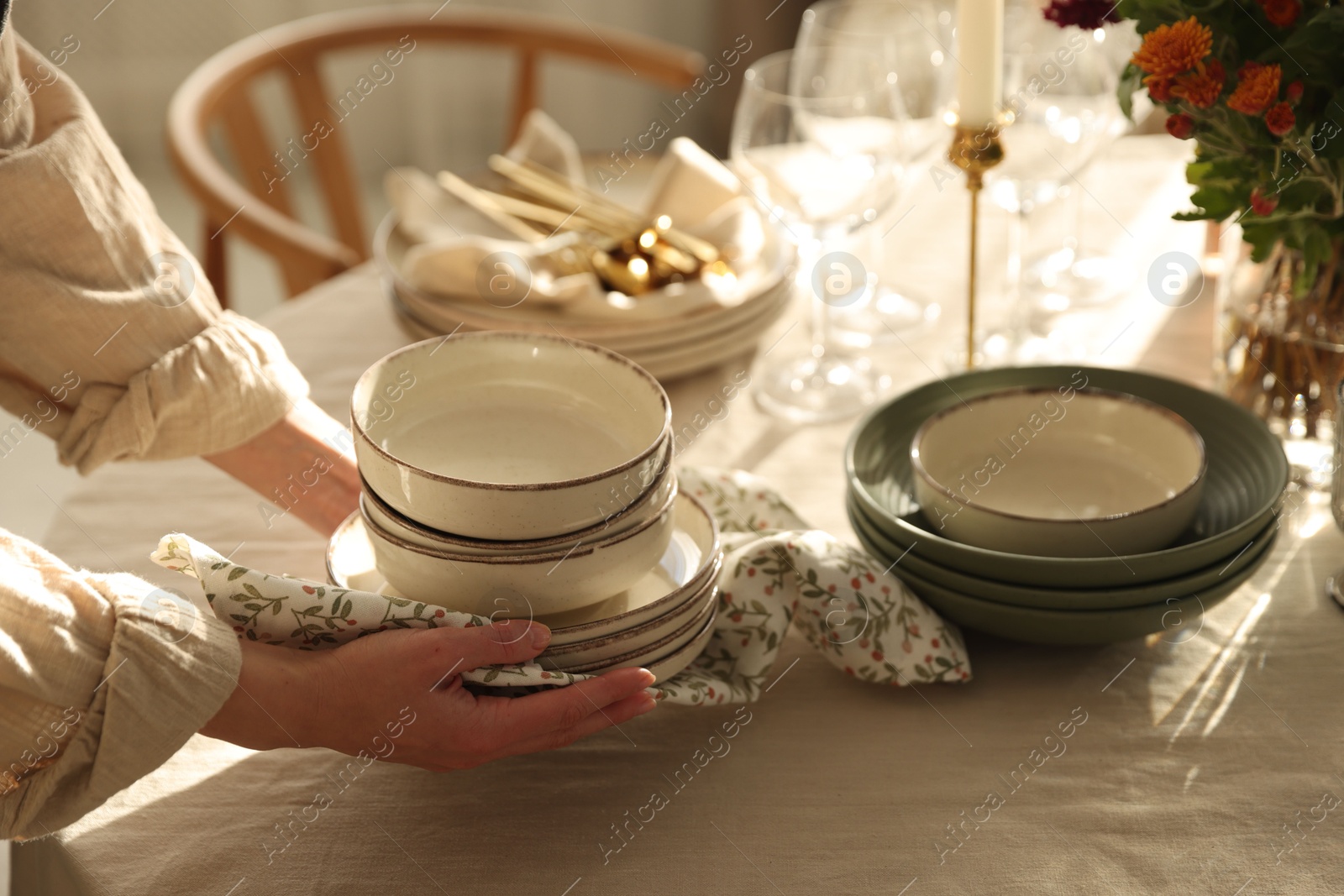 Photo of Woman setting table for dinner at home, closeup