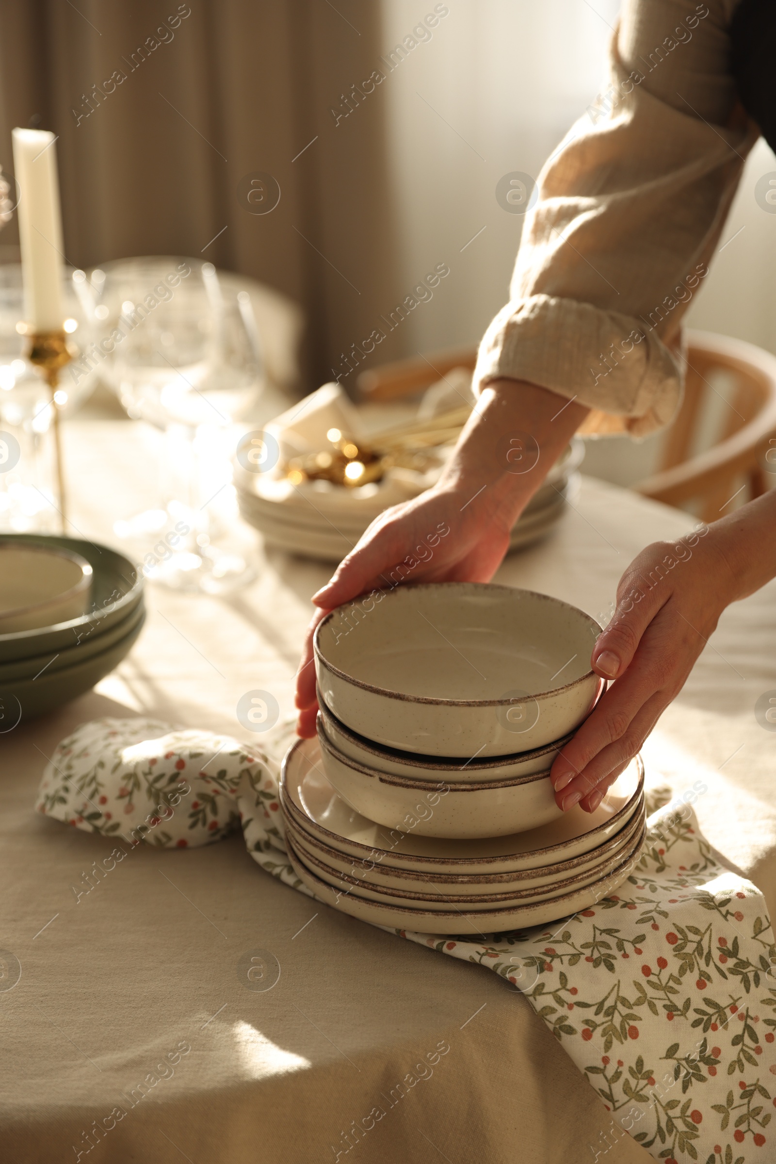 Photo of Woman setting table for dinner at home, closeup