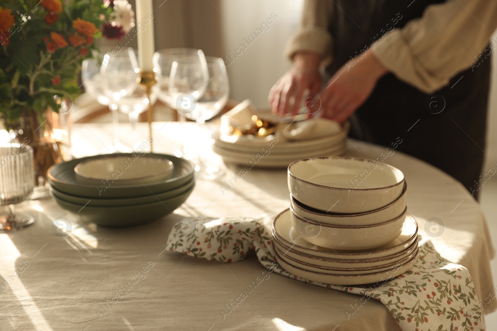 Photo of Woman setting table for dinner at home, closeup