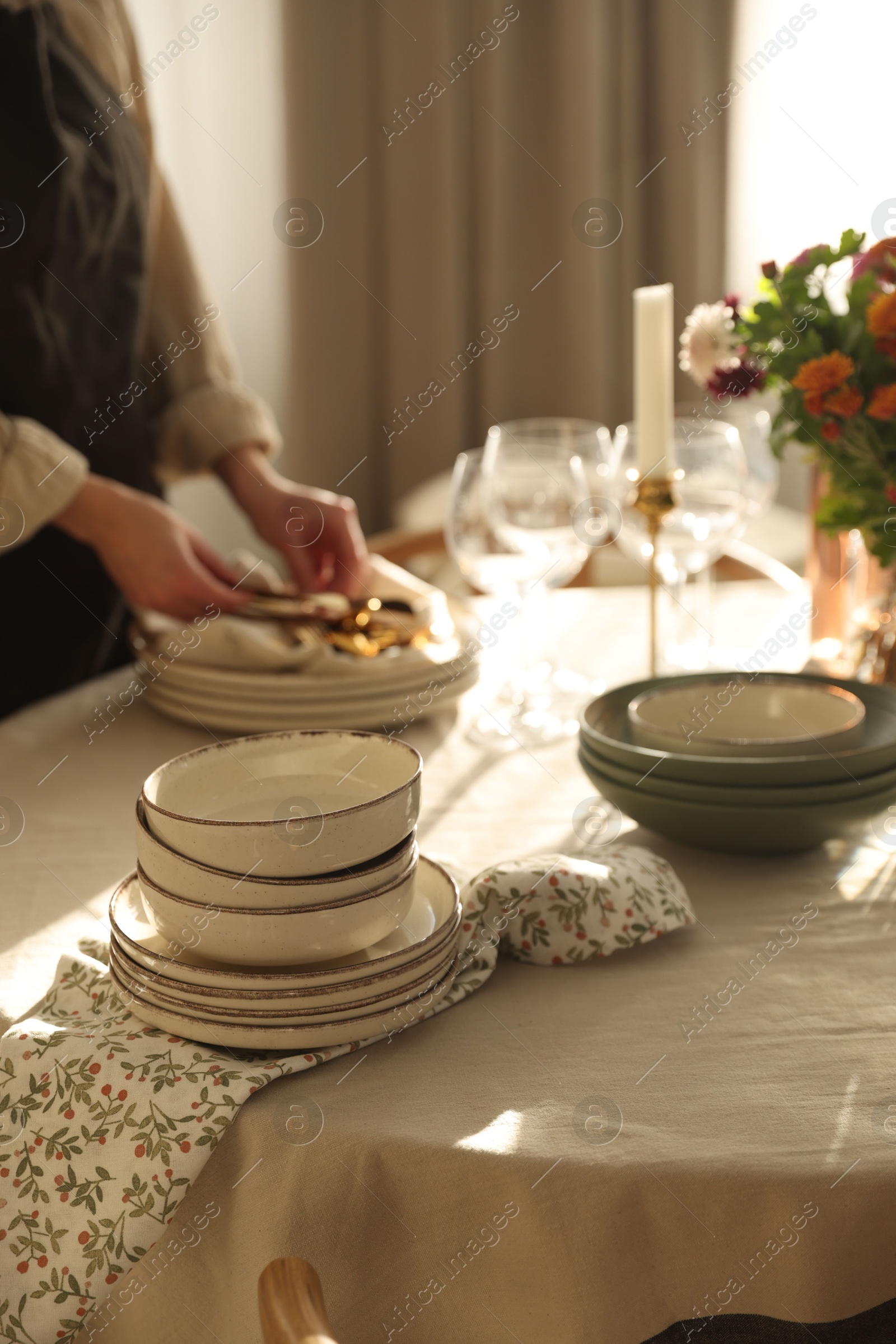 Photo of Woman setting table for dinner at home, closeup