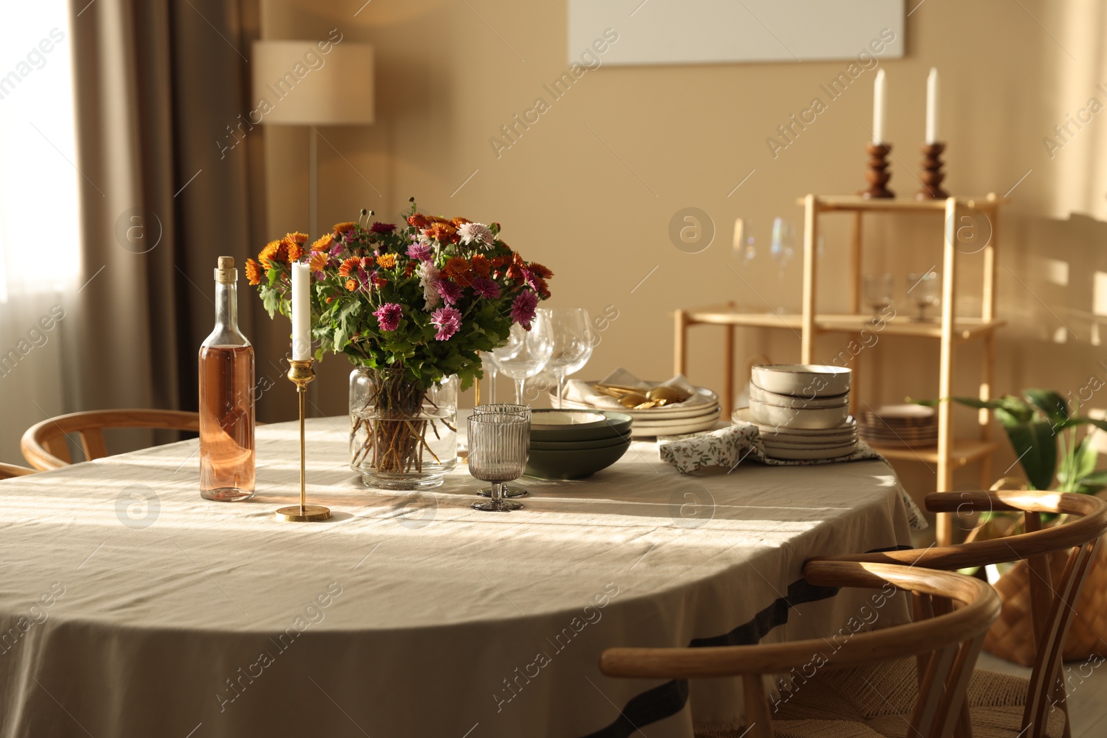 Photo of Stylish table setting with dishware, glasses and beautiful flowers indoors