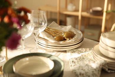 Photo of Stylish table setting with dishware, glasses and cutlery indoors