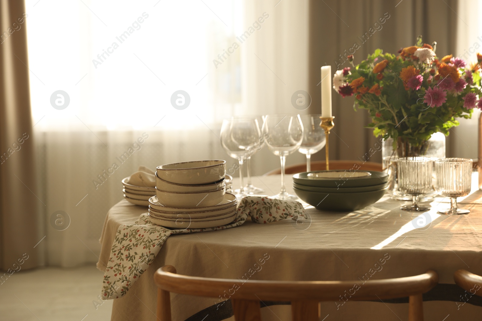 Photo of Stylish table setting with dishware, glasses and beautiful flowers indoors