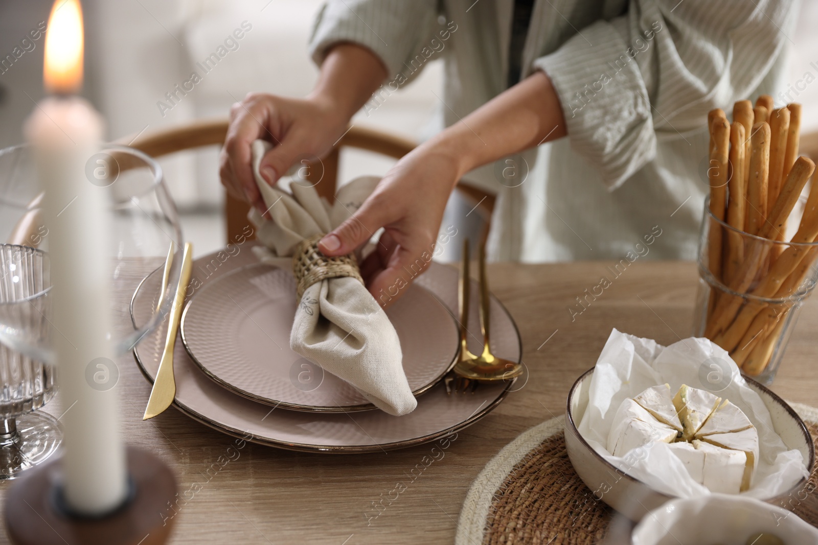 Photo of Woman setting table for dinner at home, closeup