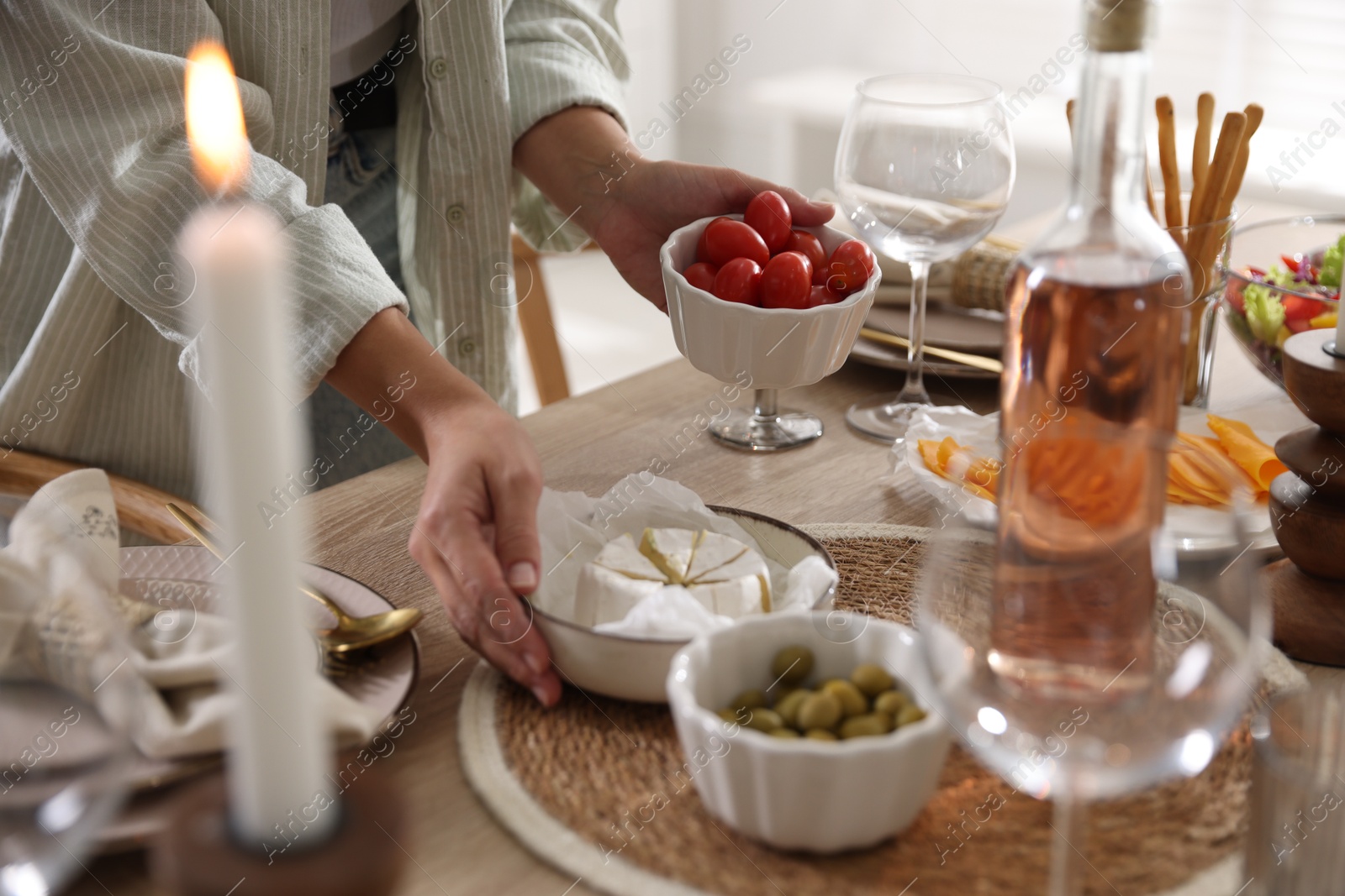 Photo of Woman setting table for dinner at home, closeup