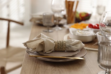 Photo of Stylish table setting with beautiful dishware, cutlery and napkin in dining room