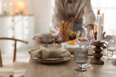 Photo of Woman setting table for dinner at home, closeup