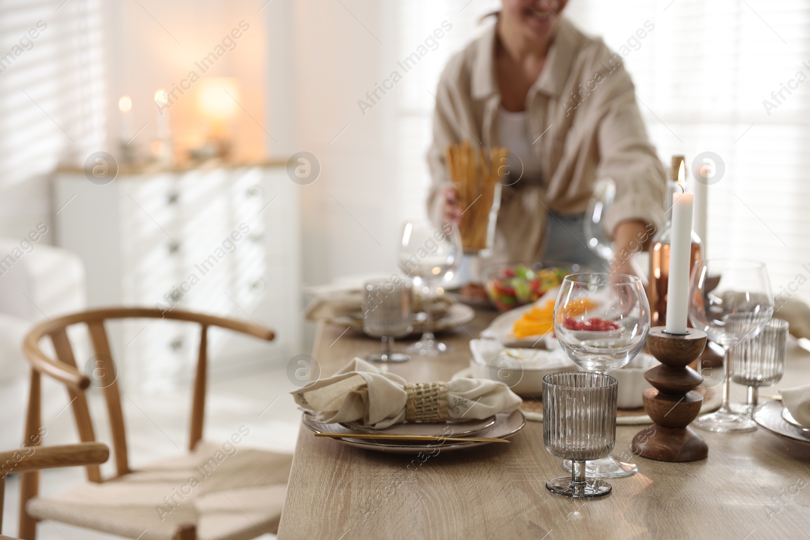 Photo of Woman setting table for dinner at home, closeup