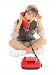 Photo of Cute little boy with old telephone on white background