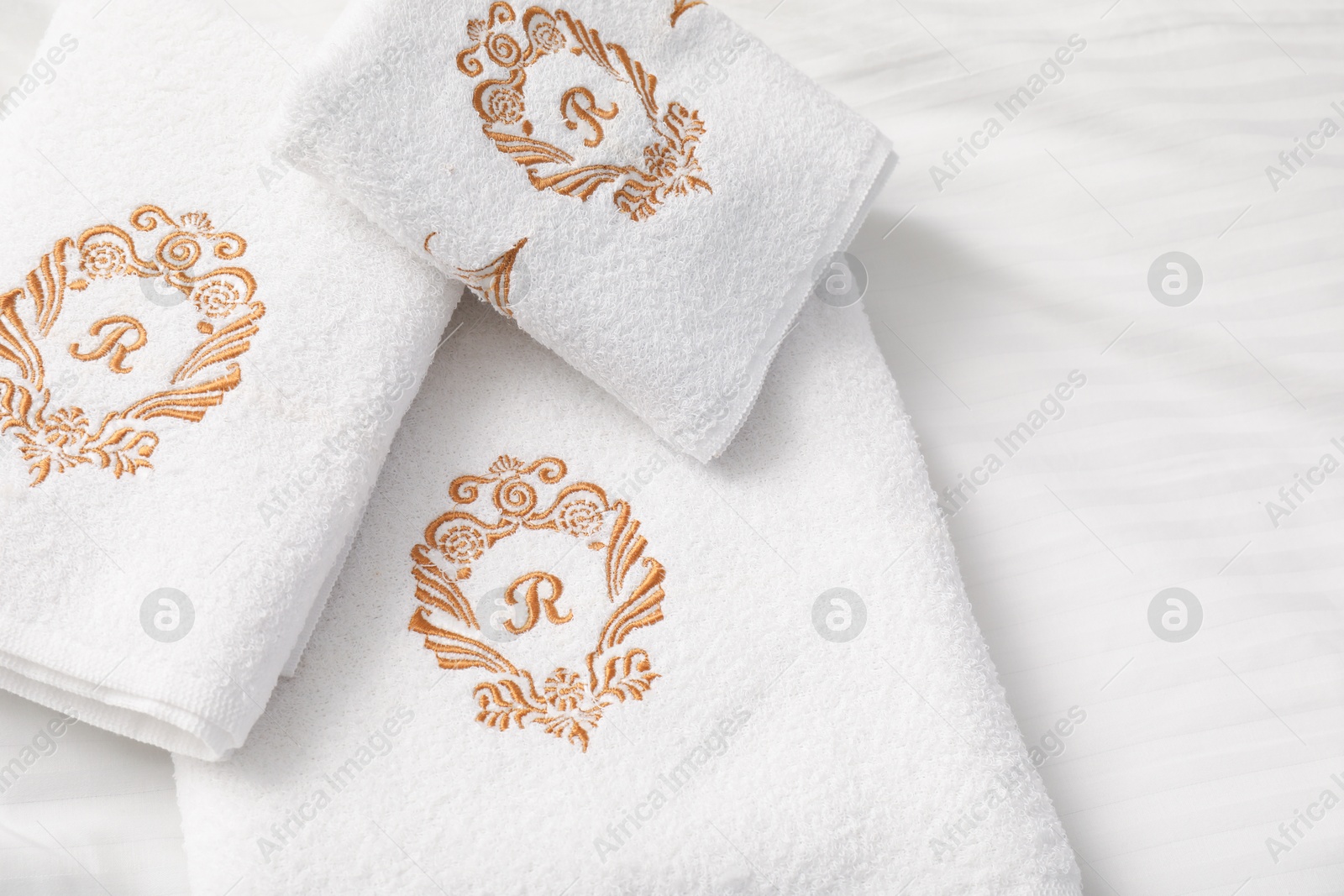 Photo of Terry towels on clean linens indoors, closeup