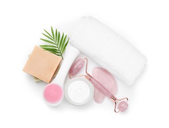 Face roller, cosmetic products, towel and gua sha isolated on white, top view