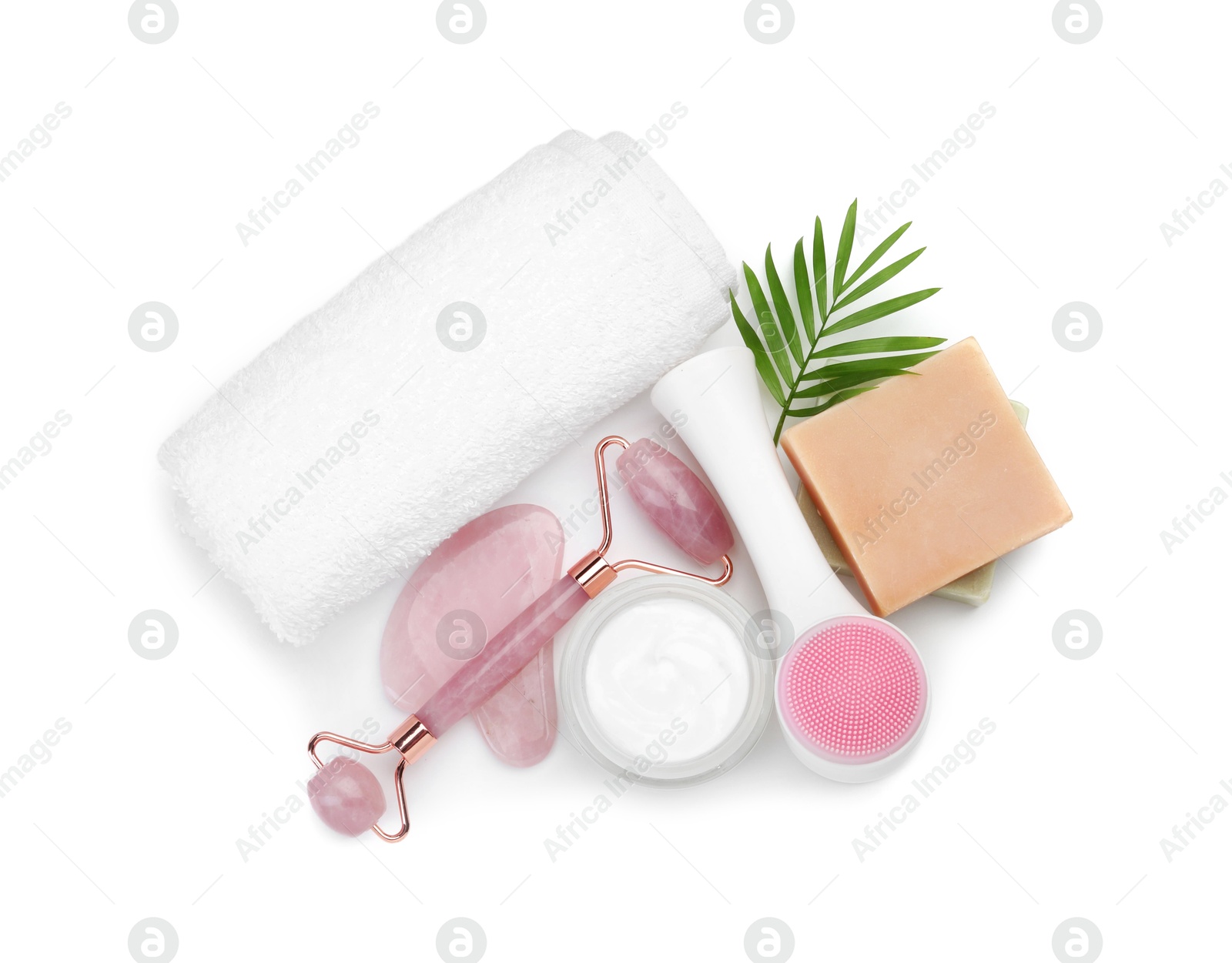 Photo of Face roller, cosmetic products, towel and gua sha isolated on white, top view