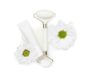 Photo of Face roller, cosmetic product, flowers and gua sha tool isolated on white, top view