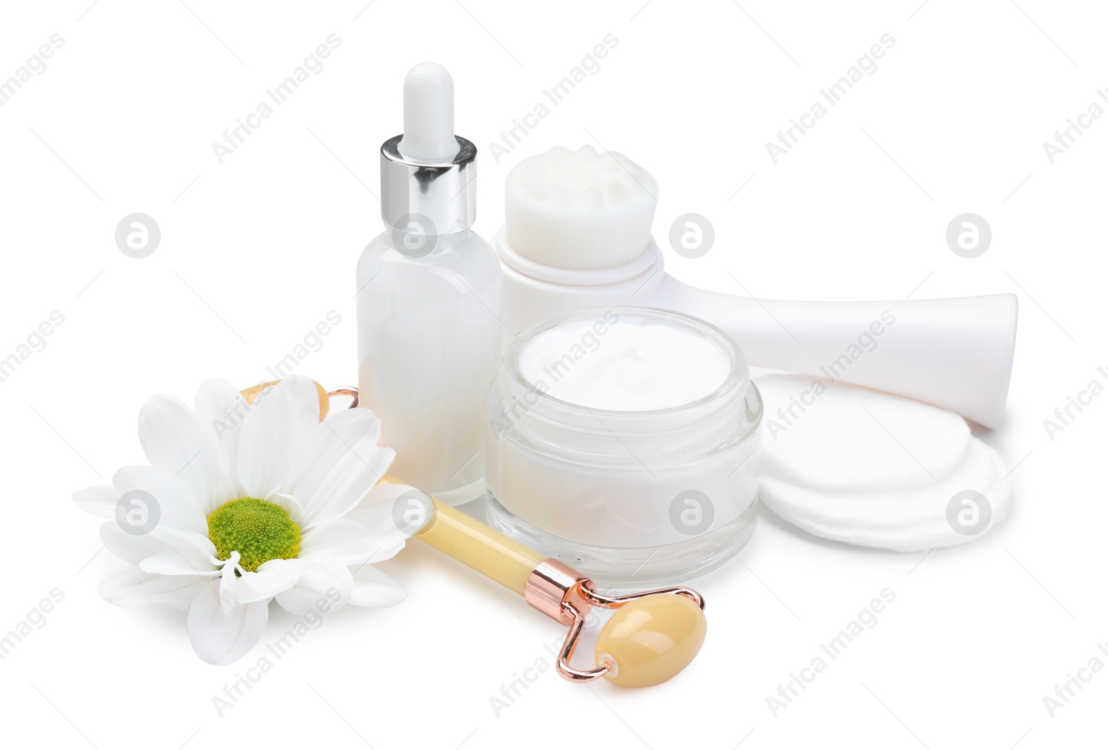 Photo of Face roller, cosmetic products and flower isolated on white