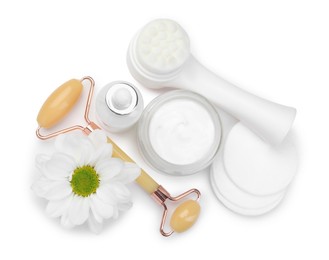 Photo of Face roller, cosmetic products and flower isolated on white, top view