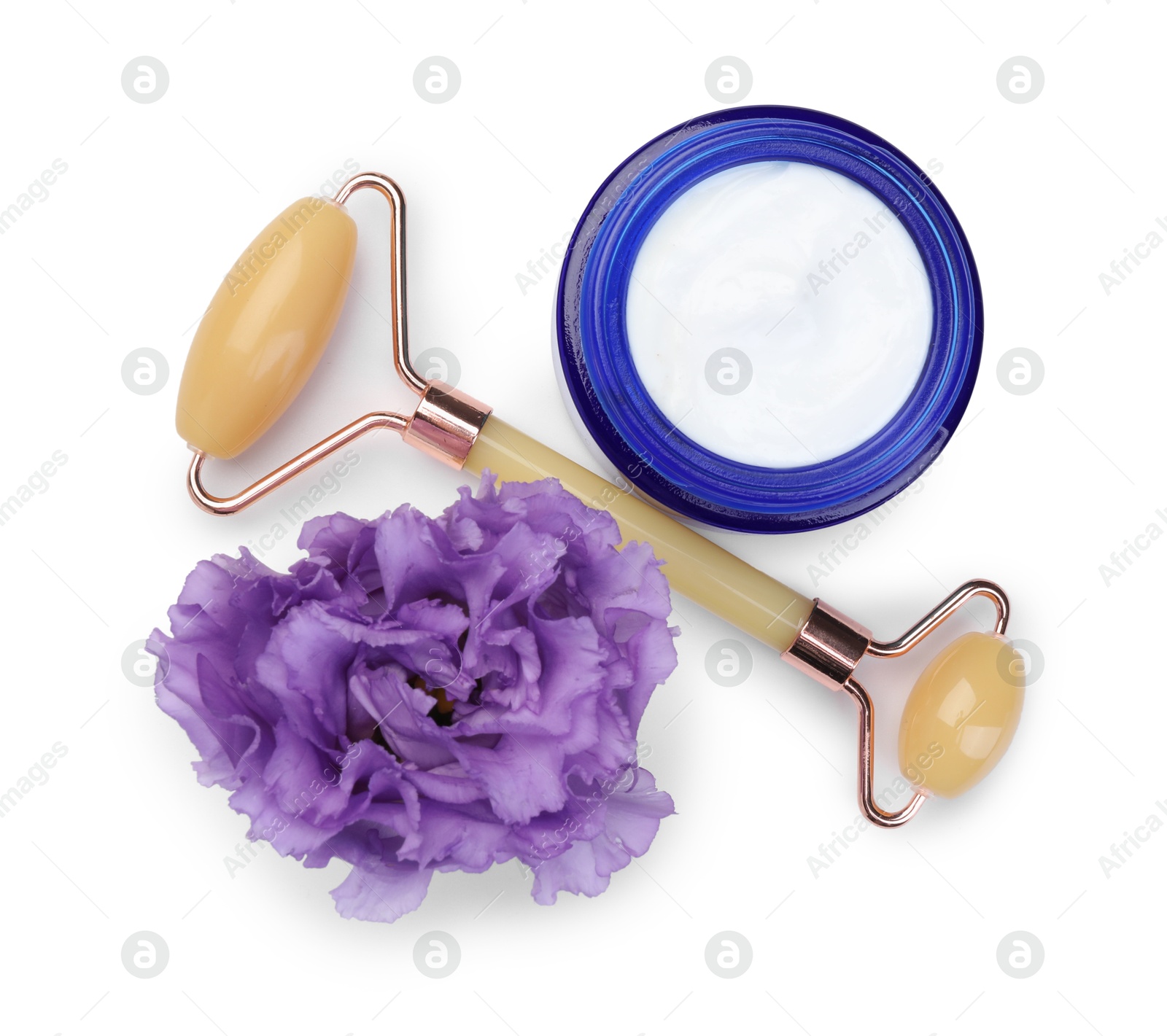 Photo of Face roller, cosmetic product and flower isolated on white, top view